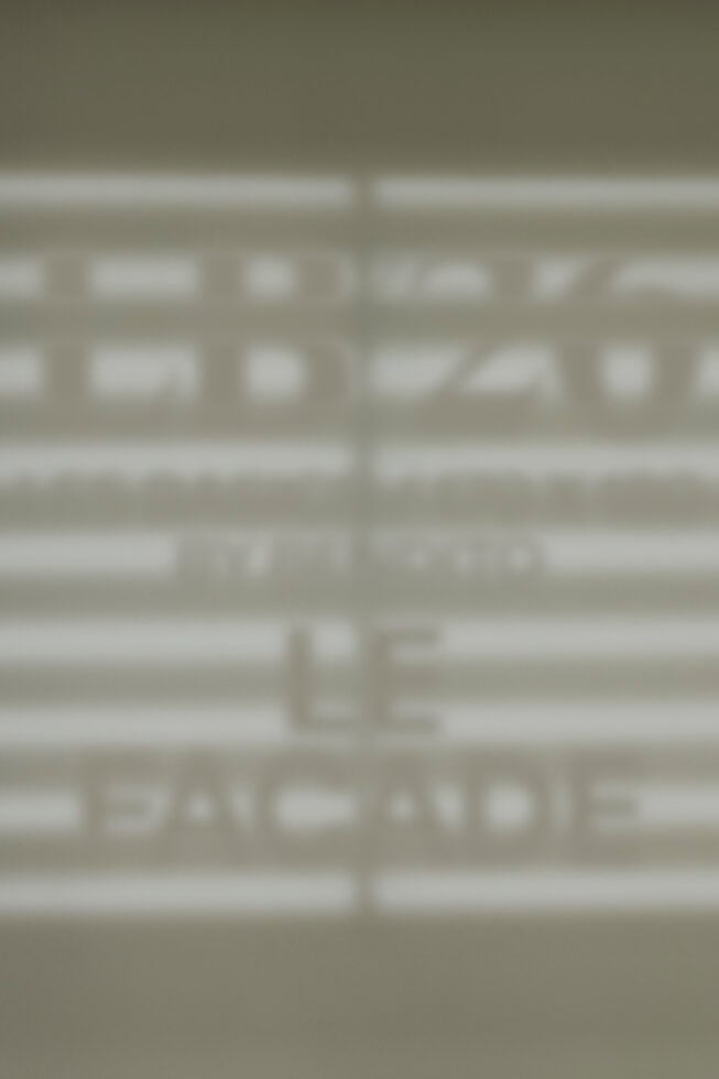 Blurred storefront window mockup showing facade signage display