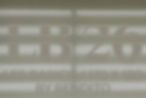 Blurred storefront window mockup showing facade signage display