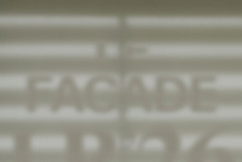 Blurred storefront window mockup showing facade signage display
