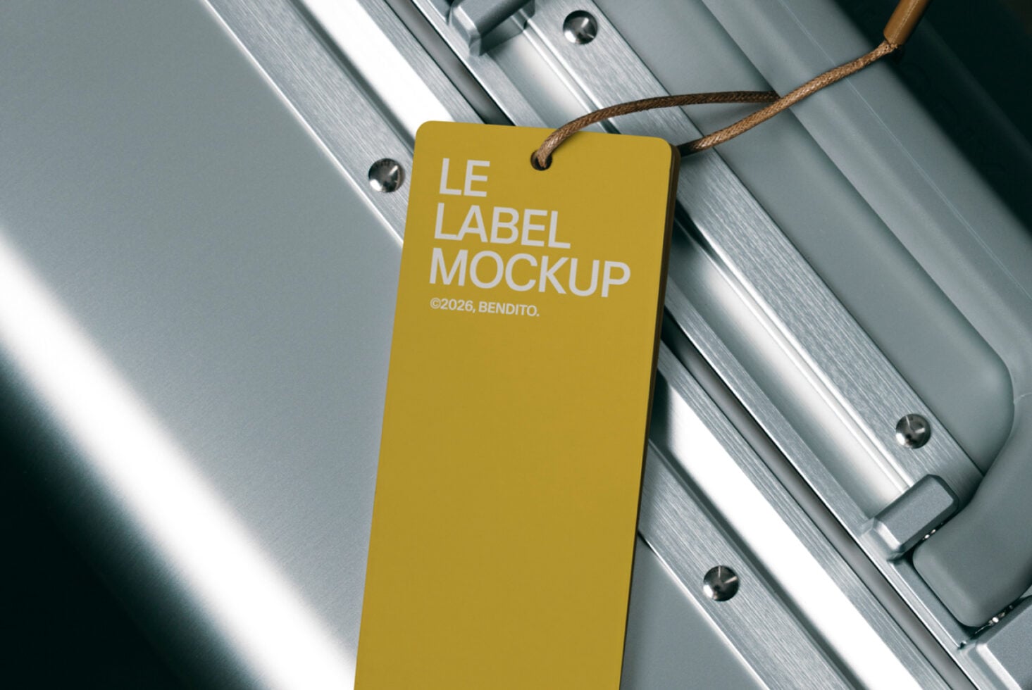Gold hang tag label mockup with rope on brushed metal background