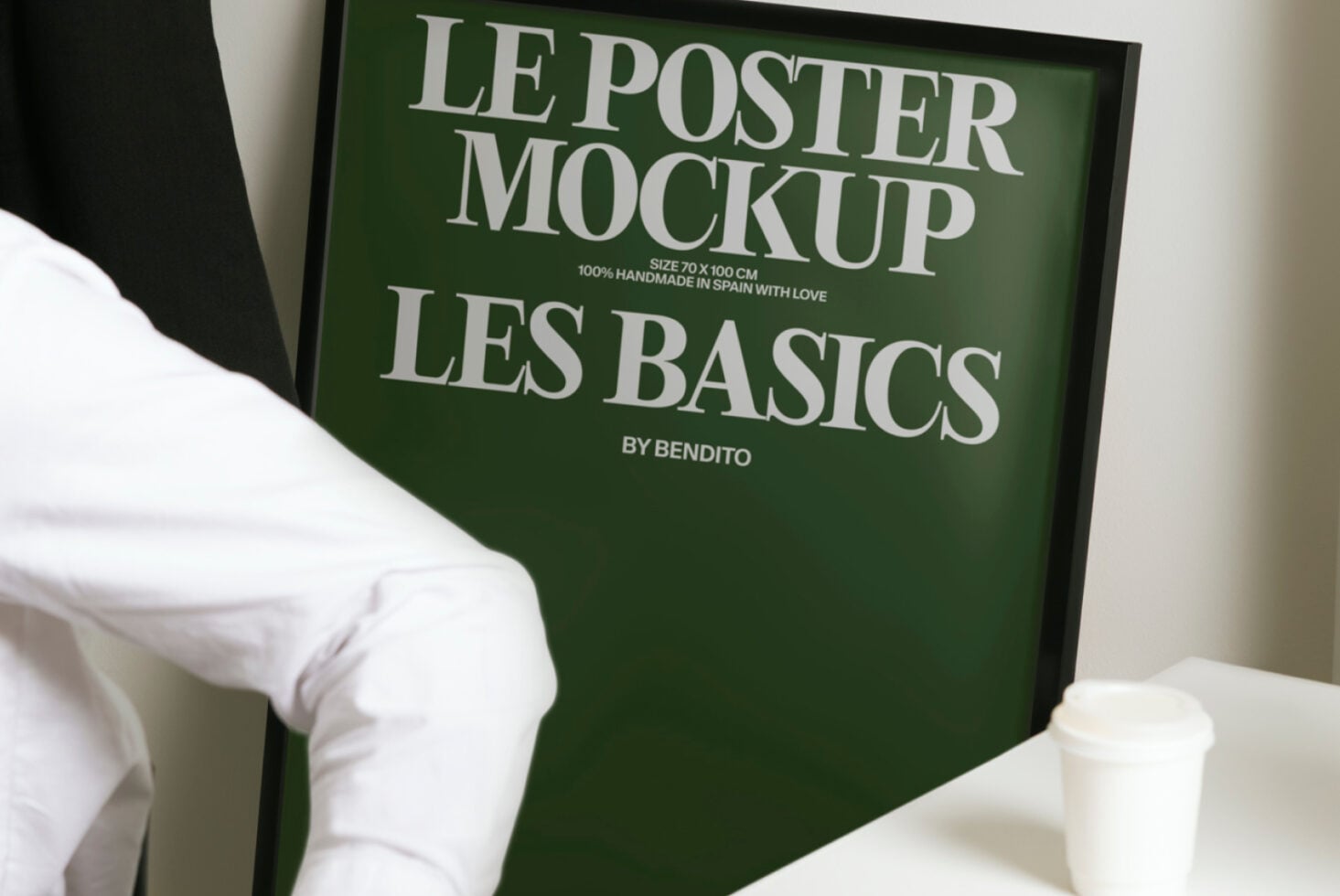 Green framed poster mockup with cream text, displayed with coffee cup in minimal setting