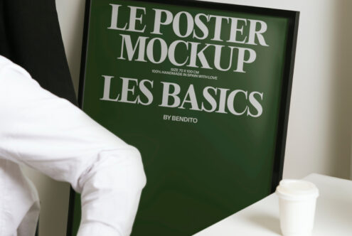Green framed poster mockup with cream text, displayed with coffee cup in minimal setting