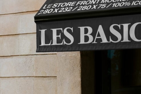 Close up of black awning with large white serif typography Les Basiq on facade