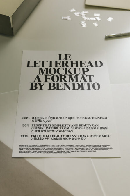 Light letterhead mockup on desk with pen, business cards scattered above