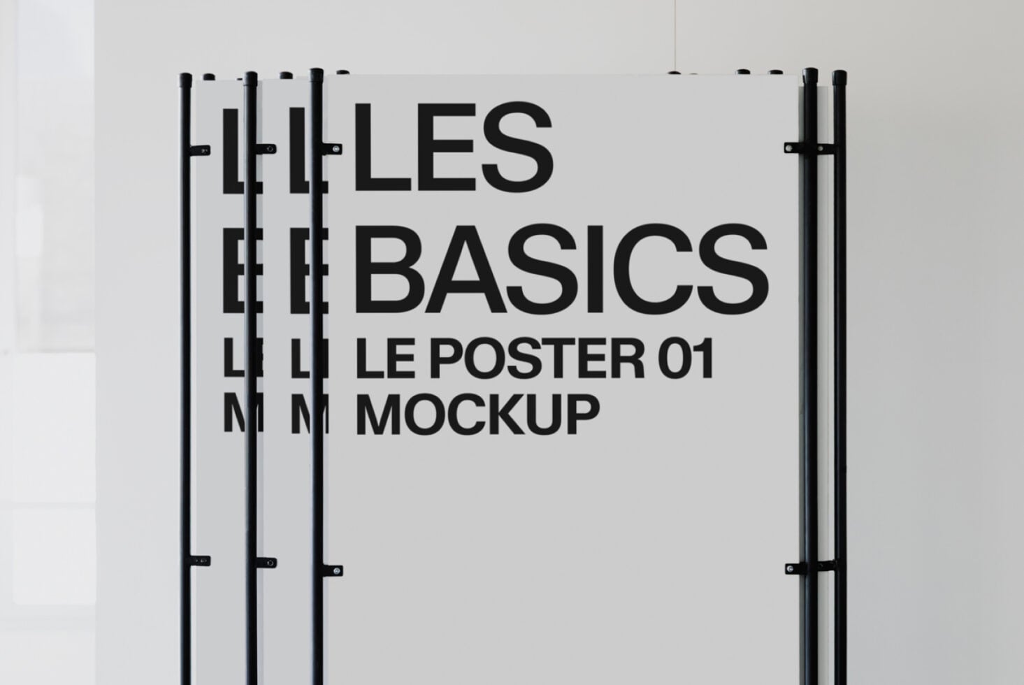 Stacked light posters with black text reading Les Basics Le Poster 01 Mockup