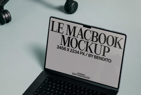 MacBook screen showing letterhead mockup template with headphones nearby