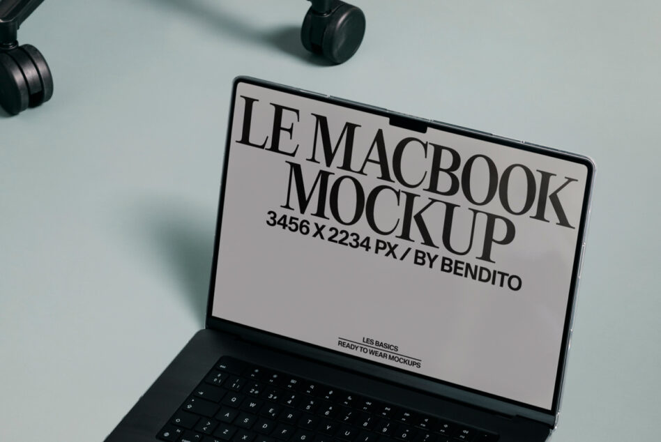MacBook screen showing letterhead mockup template with headphones nearby