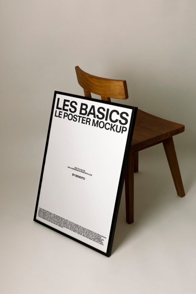 White poster leaning on wooden chair showing Les Basics branding by Bendito