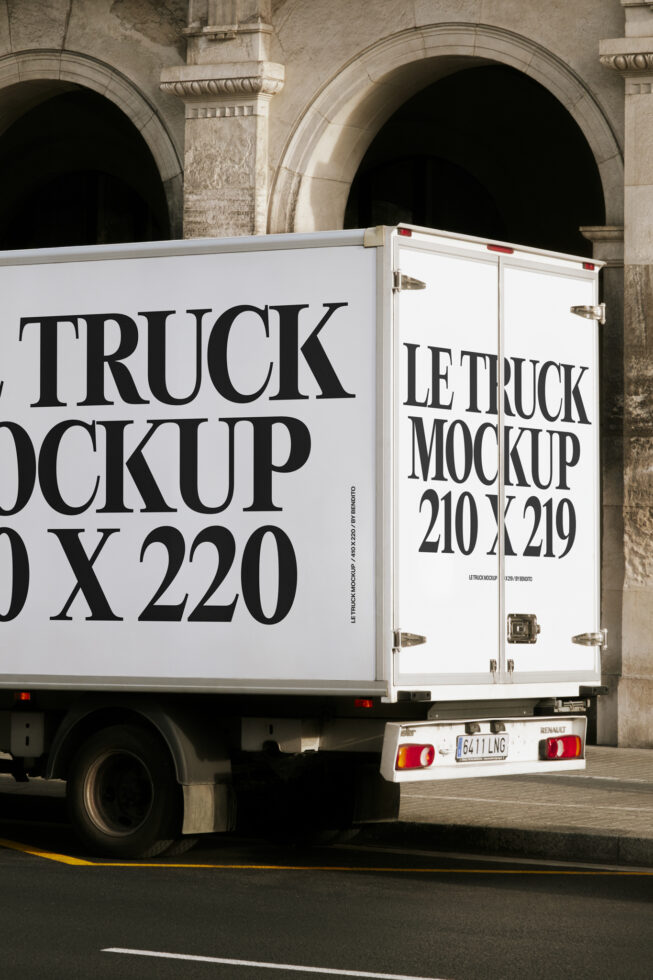 White delivery truck with black text showing truck door mockup dimensions against stone archways