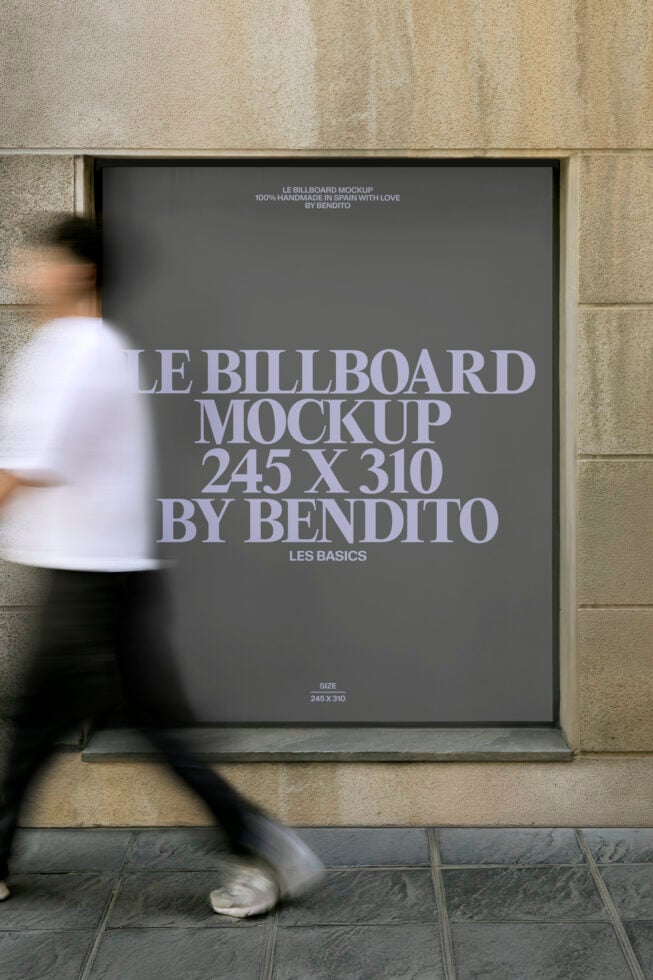 Street-level billboard mockup on stone wall with blurred person walking by