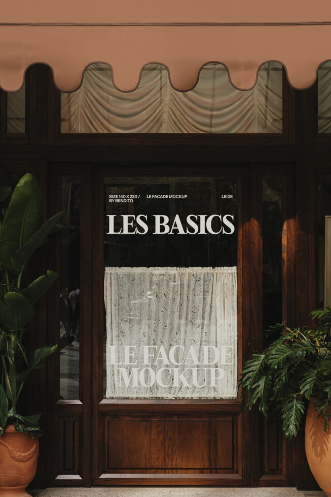 Storefront facade with terracotta awning displaying Les Basics window signage