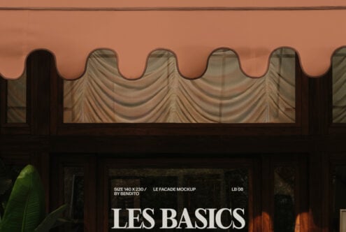 Storefront awning with draped fabric displaying Les Basics branding on window