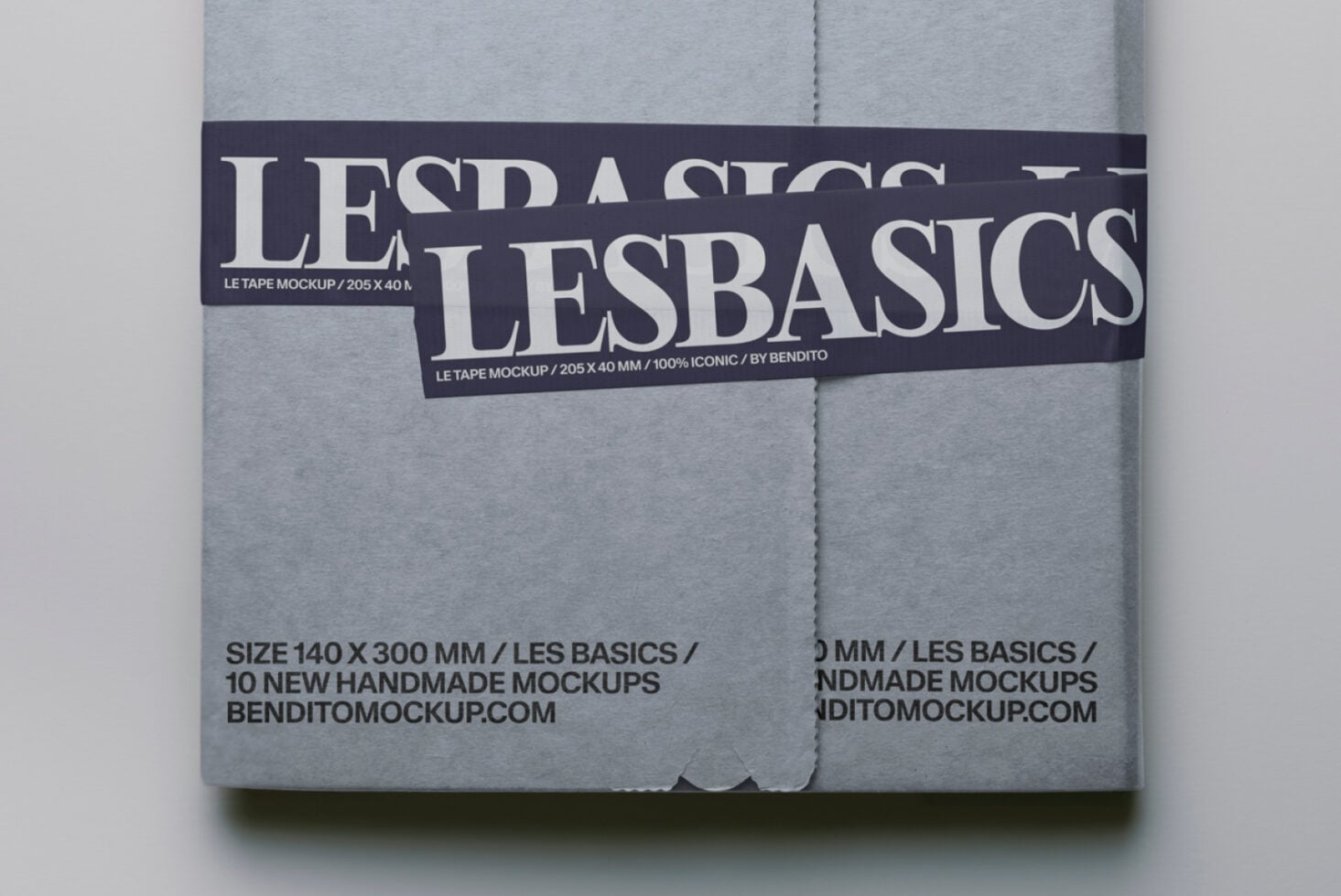 Gray mailer mockup tied with dark Les Basics tape featuring serif lettering