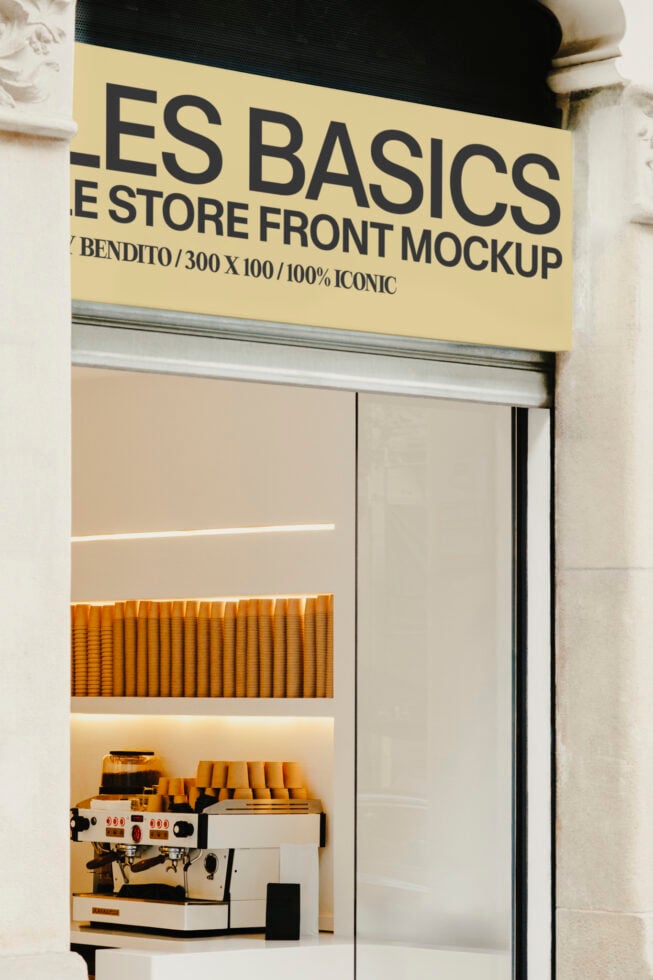 Cream storefront with yellow sign showing cafe interior with espresso machine