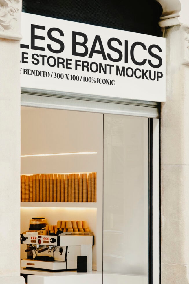 Cream storefront with yellow sign showing cafe interior with espresso machine