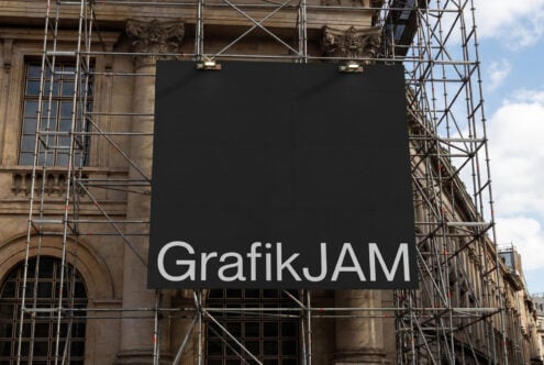 Black construction billboard with white GrafikJAM text on building facade