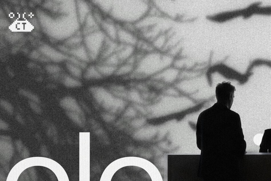 Black silhouette figure on stage with blurred crowd background, monochrome