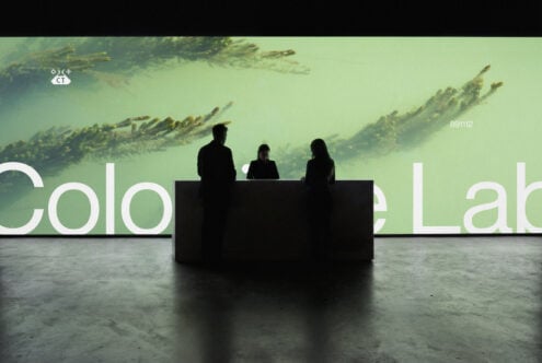 Panel of three silhouettes at table with green forest projection behind