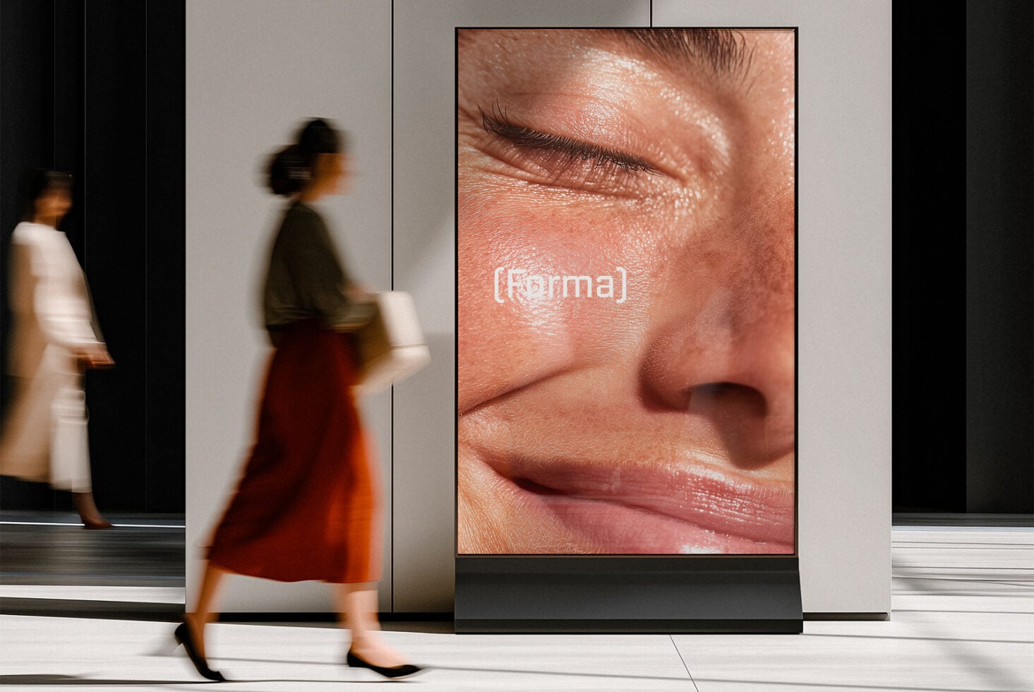 Large vertical screen displaying detailed skin close-up with (forma) watermark in modern lobby