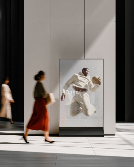 Woman passing modern display showing man in cream outfit against clean white wall