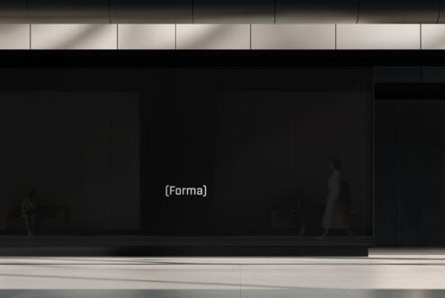 Dark storefront display with minimal signage in urban setting