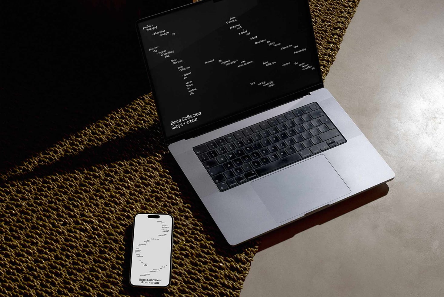 Laptop showing dark design layout, phone with matching dark screen below