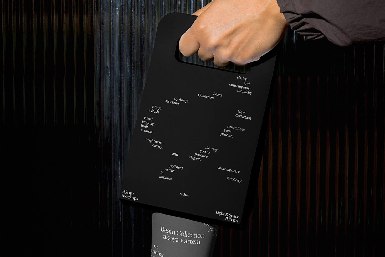 Hand gripping black clipboard with white typography scattered across surface