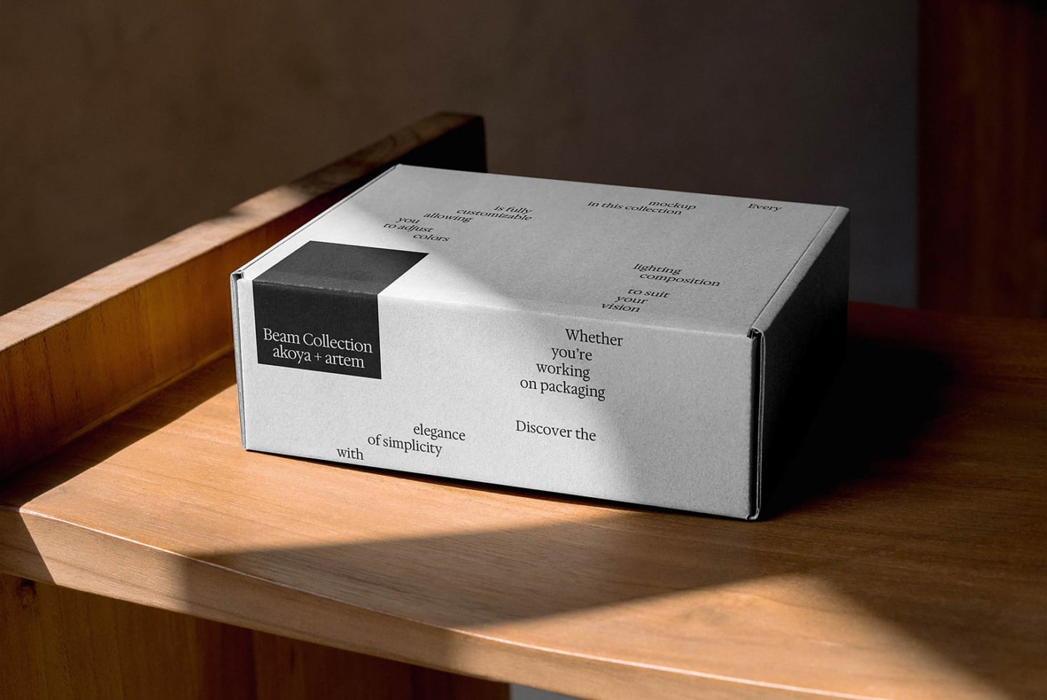 White shipping box with printed text layout on wooden surface by window