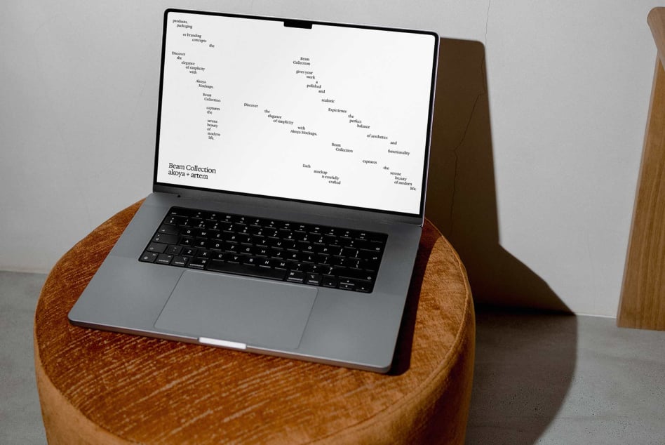 Laptop on wood table displaying website mockup with light background