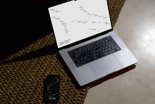 Laptop displaying light design layout, phone with matching light screen below
