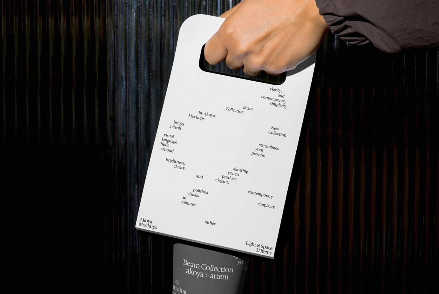 Hand holding white clipboard displaying typography layout with coffee cup below