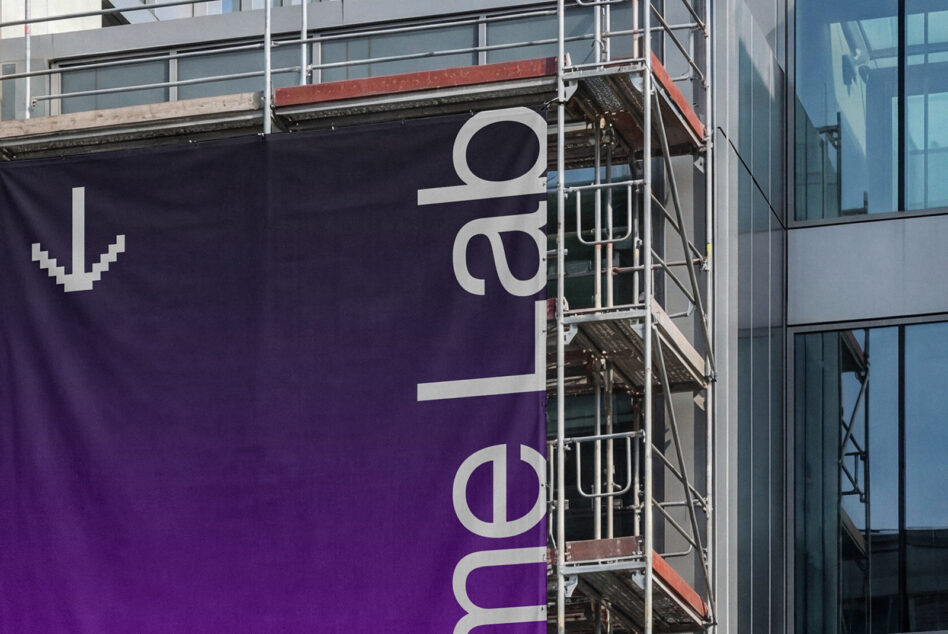 Purple construction banner with ColorLab branding on building facade
