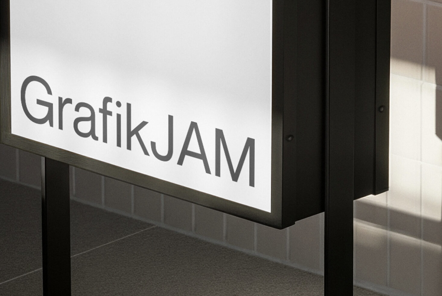 Outdoor lightbox sign with GrafikJAM text in modern sans-serif font