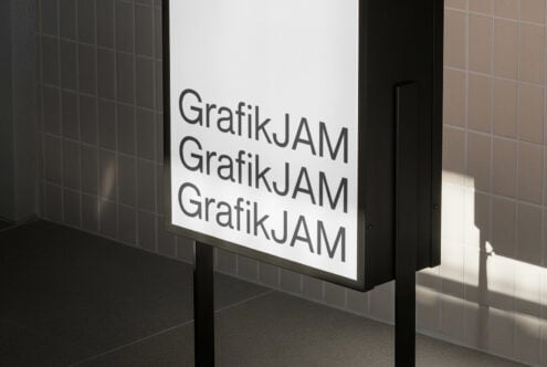 Repeating GrafikJAM text stacked vertically on white lightbox panel