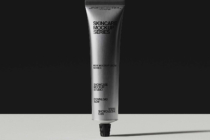 Silver tube with skincare mockup label on black backdrop