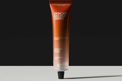 Orange tube with skincare mockup label on black backdrop