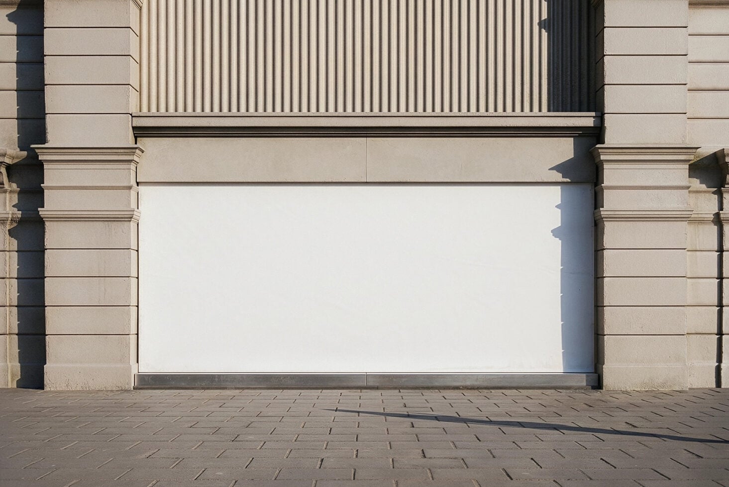 Blank storefront window with cream architectural trim in daylight
