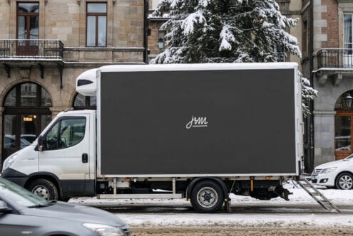 Delivery truck side panel mockup in charcoal with minimalist script branding