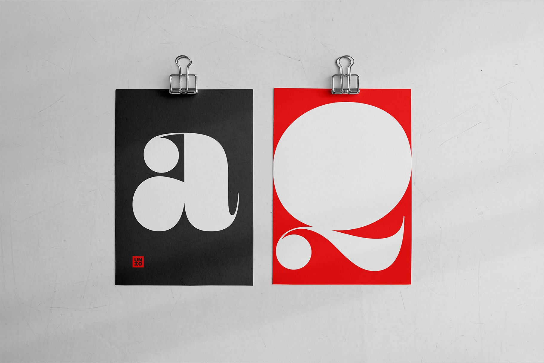 Two clipped posters showing minimalist circular logo designs in black, white, red