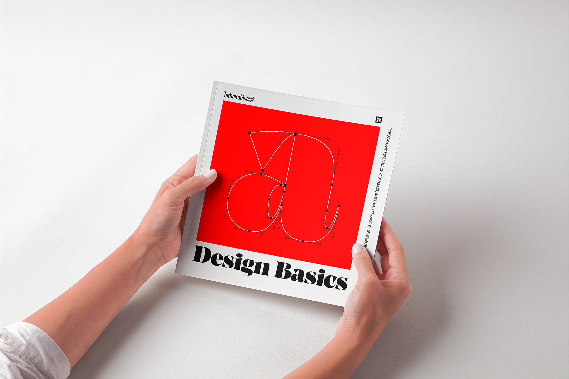 Hands holding Design Basics book with red cover featuring wire frame circles