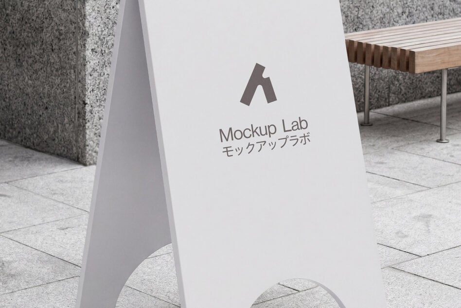 Minimalist white A-frame sign displayed on concrete storefront