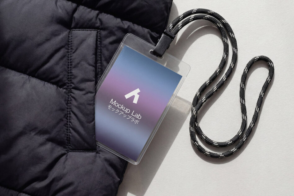 Phone with gradient screen attached to black braided cable on dark jacket