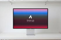 Desktop monitor showing red to blue gradient background with white logo