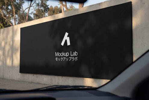 Black concrete sign mockup showing white Mockup Lab logo in sunlit outdoor setting