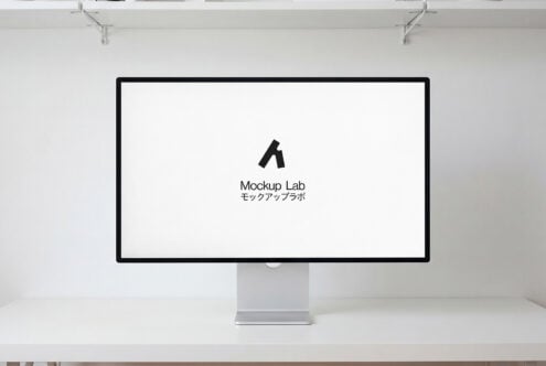Desktop monitor with pink to blue gradient displaying white logo on desk