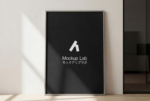 Framed poster with black background displaying white logo on gallery wall
