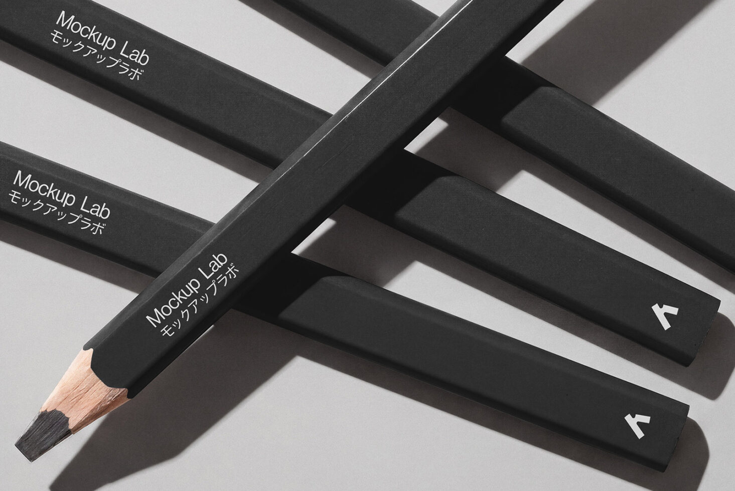 Black pencils with white text arranged in overlapping pattern on light background