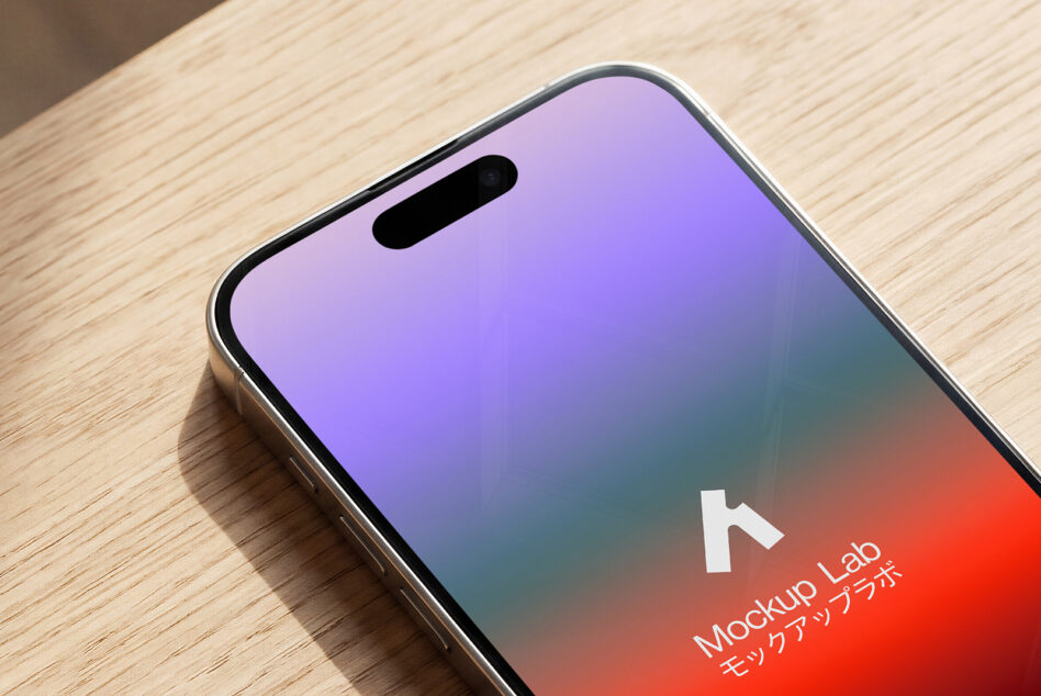 Phone mockup on wood surface showing colorful gradient display screen