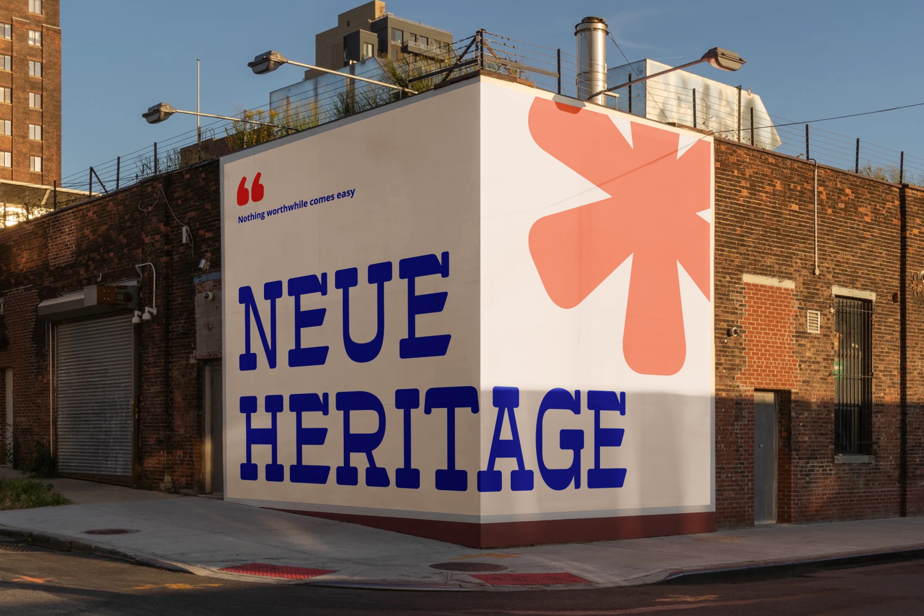 Large corner building sign reading Neue Heritage in blue with coral shape