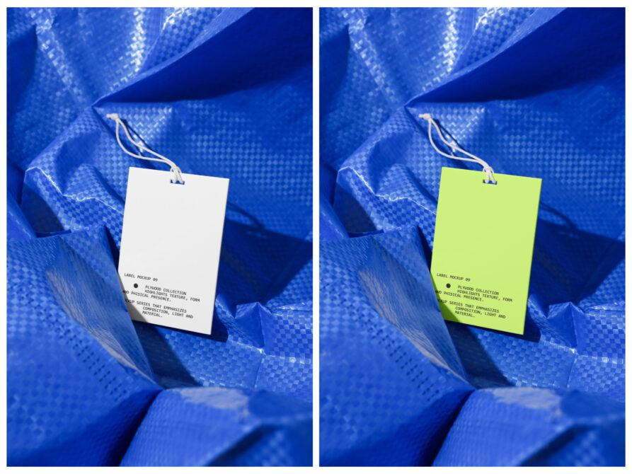 Two clothing tags hanging on blue mesh fabric, one white one neon yellow with string